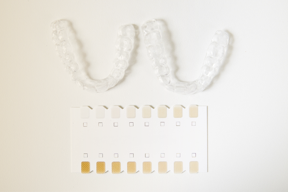 Clear aligners placed on a clean white surface, showcasing their transparency and precise fit.